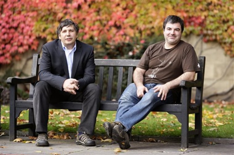 Nobel-winning physicists Andre Geim, left, and Konstantin Novoselov sit on a bench outside Manchester University in England on Tuesday, after hearing that they have won the prestigious physics prize.